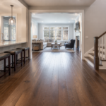 Flooring home value New Jersey — Modern living room with polished hardwood floors and large windows showcasing natural light